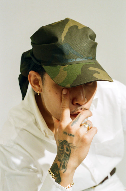 Stylish unisex camo tie hat with adjustable fit, shown on a white background. This camouflage cap features a unique tie-back design, perfect for outdoor activities, streetwear, and everyday casual fashion. Durable, lightweight, and breathable—ideal for men and women who love camo fashion or need a tactical look. Shop now for the best camo tie hat online.