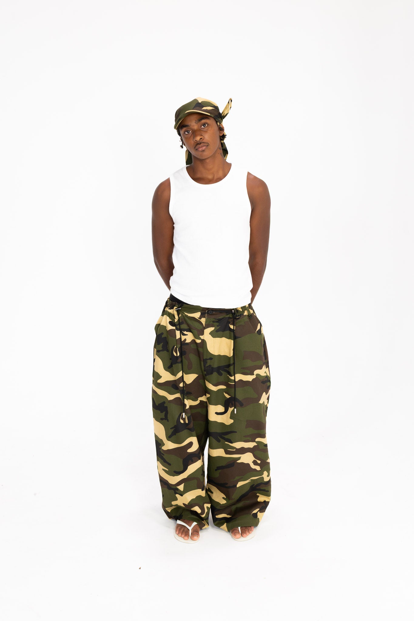 streetwear look with camo pants and adjustable tie hat