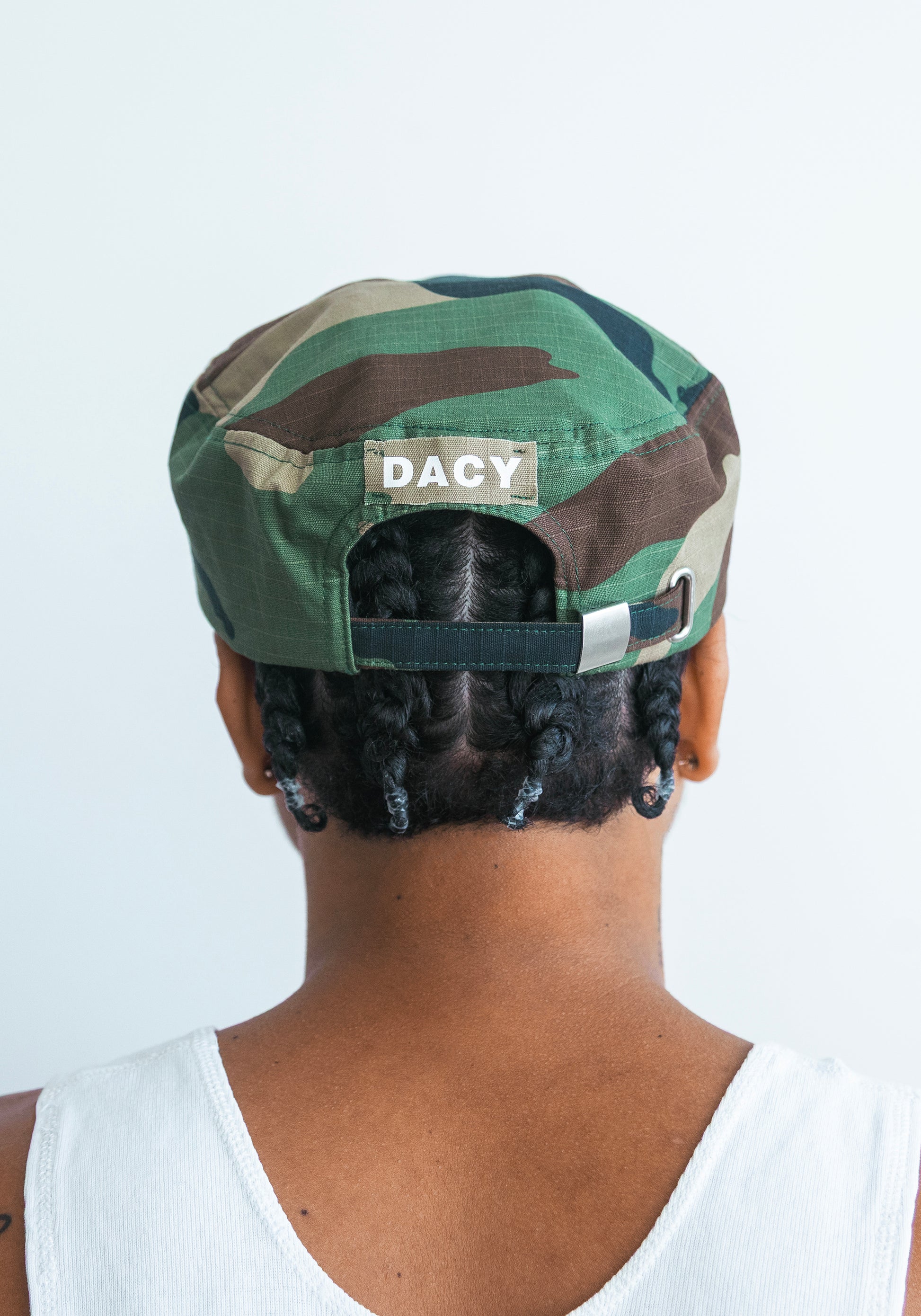 DACY short brim camo hat back view showing DACY label and strap
