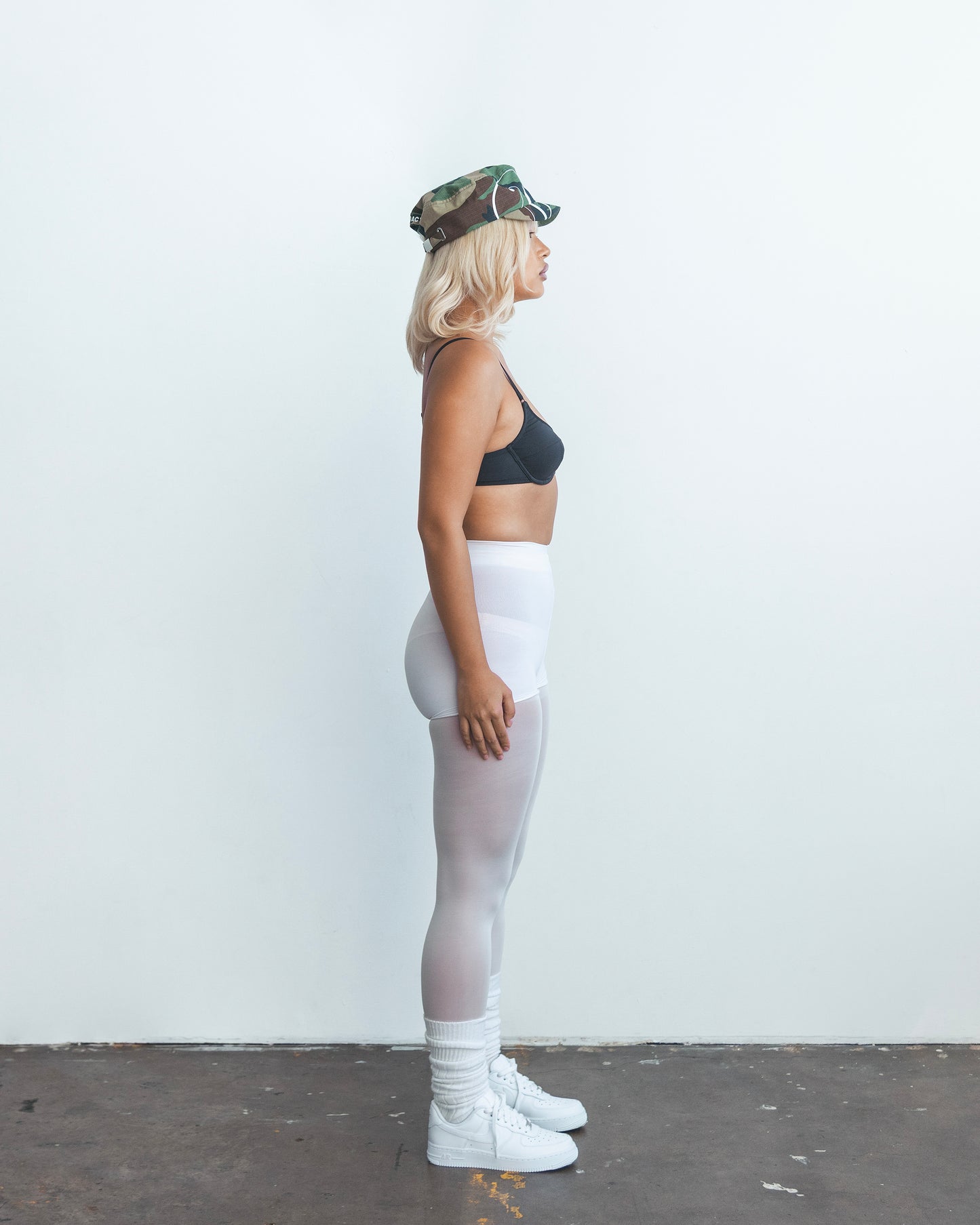 DACY short brim camo hat worn in full body side profile shot