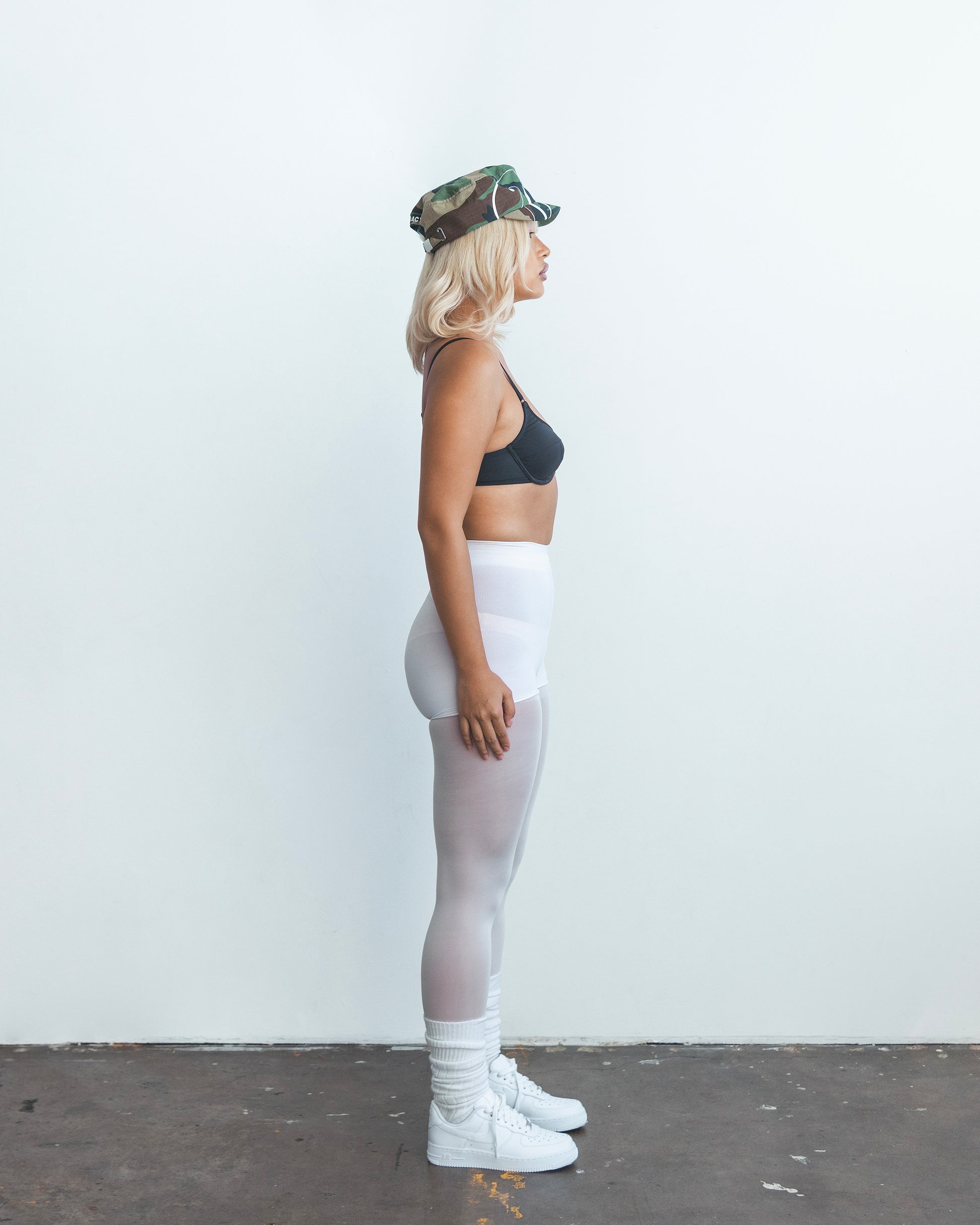 DACY short brim camo hat worn in full body side profile shot