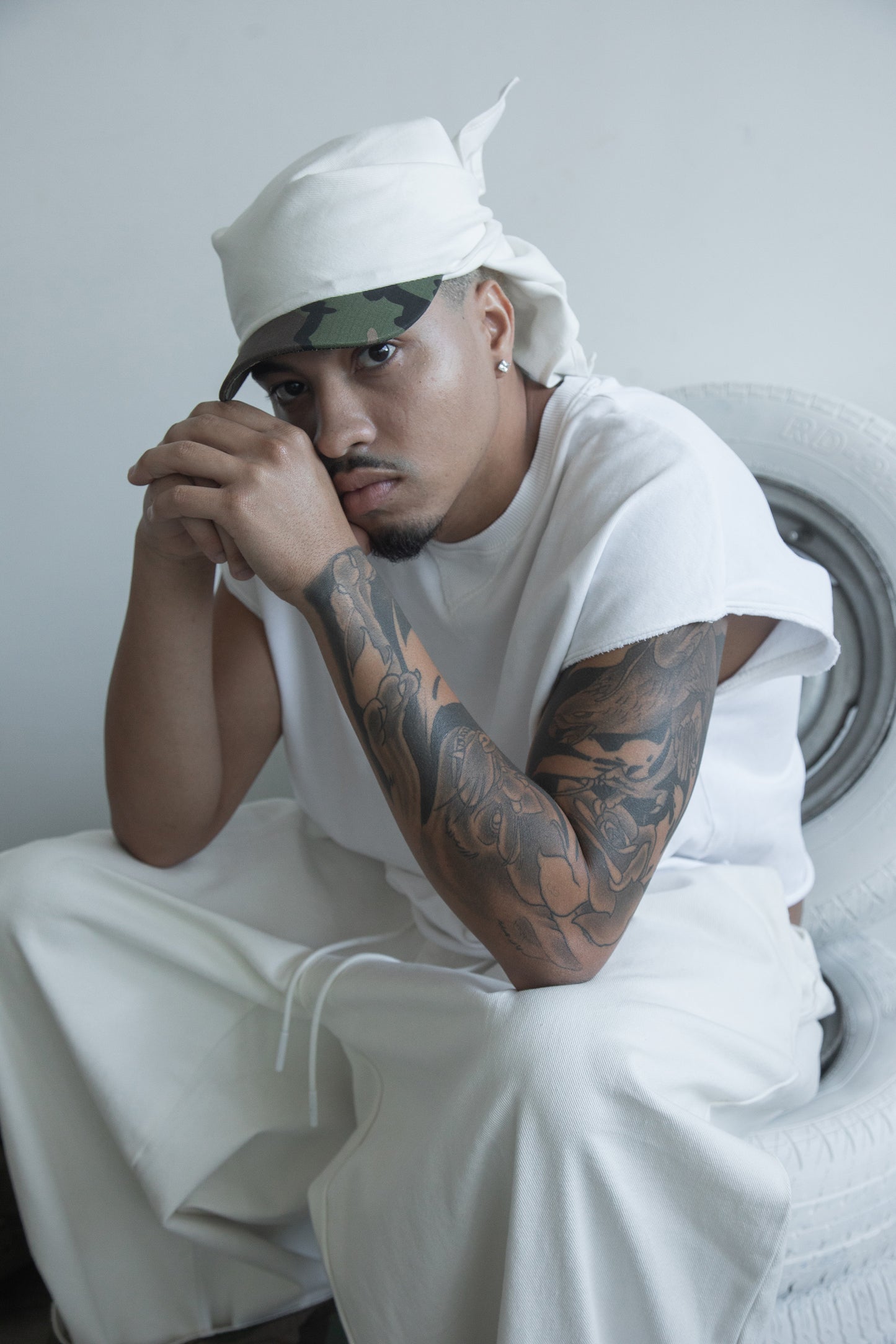 DACY Studio Tie Hat in off-white cotton drill featuring a short camouflage brim, adjustable tie-back and versatile unisex design.