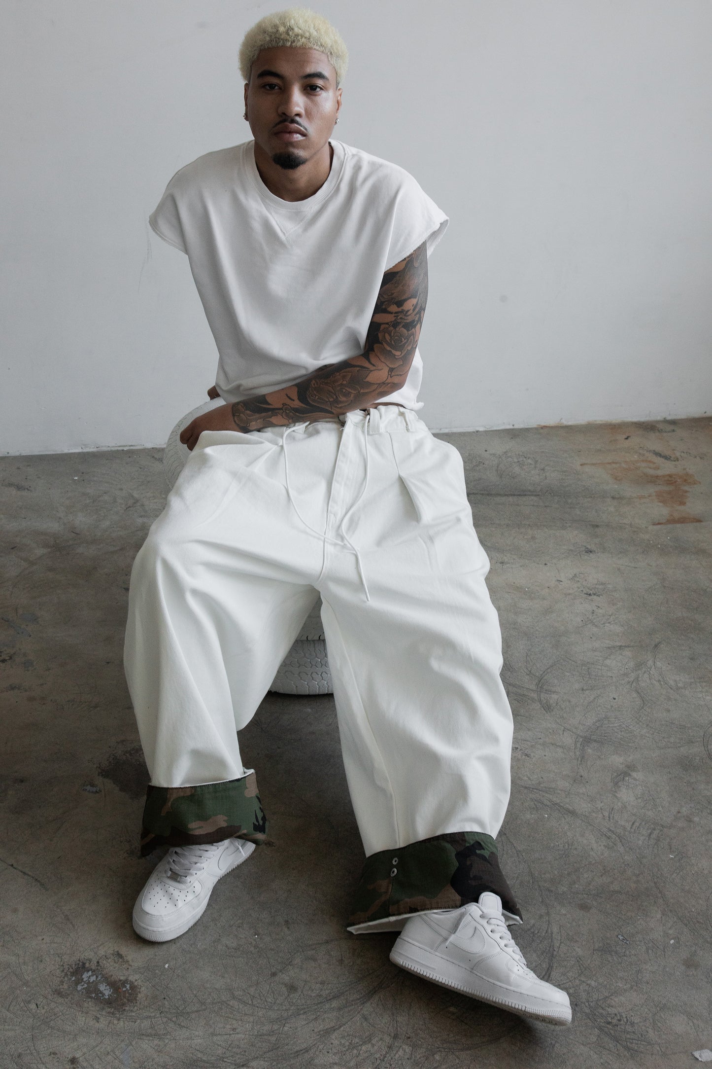 off-white cotton drill with adjustable camo clip-up hems, oversized unisex fit and elastic drawstring waist 