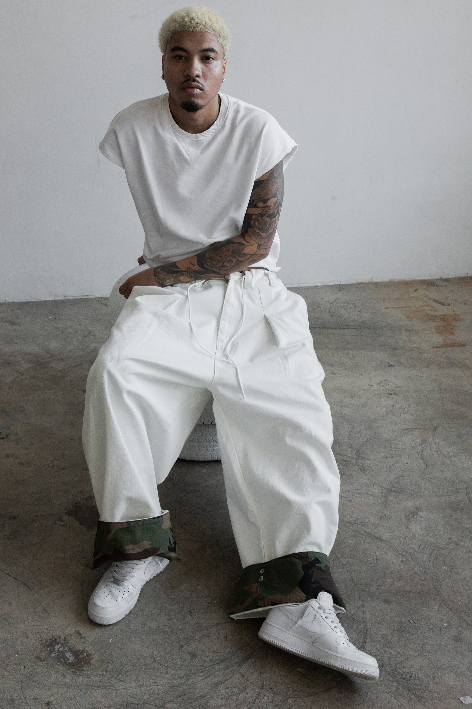 off-white cotton drill with adjustable camo clip-up hems, oversized unisex fit and elastic drawstring waist 